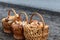 Paved country road in the mountains and three baskets of large porcini mushrooms for sale.