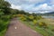 Paved country road turned into a natural walk for hiking next to lake