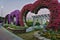 Paved footpath in the park. On the side of the road, there are heart-shaped arches