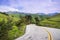 Paved road going through verdant hills, Mount Hamilton in the background, south San Francisco bay, San Jose, California