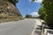 Paved road in the mountains among the greenery, blue sky, road i