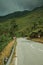 Paved road passing through hilly landscape