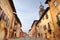 Paved street among historic houses in Saluzzo.