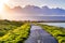 Paved trail illuminated by the evening sunlight on the shoreline of south San Francisco bay area, Mountain View, California