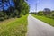 A paved walking path at the Augusta Canal with power lines