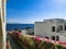 Paved yellow brick road in perspective leading to the sea on the background of blue sky