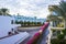 Paved yellow brick road in perspective leading to the sea on the background of blue sky