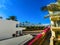 Paved yellow brick road in perspective leading to the sea on the background of blue sky