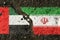 On the pavement, the images of the flags of the United Arab Emirates and Iran, as a symbol of confrontation.