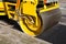 Pavement machine laying fresh asphalt or bitumen on top of the gravel base during highway construction.