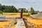 Pavement repairs and paving slabs laying on the prepared surface, with tile cubes in the background. Laying paving slabs in the