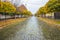 Pavement road in a small cozy town in autumn after rain. Yellow