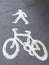 Pavement, sidewalk signs for cyclists and pedestrians. Cycle path, route. Bicycle and person