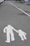 Pavement sign of a person and child