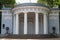 A pavilion standing in the Park, decorated with a rotunda with white columns, bas-reliefs and cast-iron vases