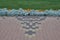 Paving stones laid out in a pattern along the flowerbed with flowers and green grass