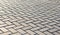 Paving tiles of gray color laid geometrically correct pattern for walking
