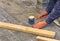 Paving the tiles on the sidewalk, the worker lay the tile, aligning it on the thread