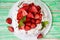 Pavlov`s cake with strawberries and cream on a rustic background