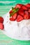 Pavlov`s cake with strawberries and cream on a rustic background, selective focus, close up