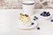 Pavlova Dessert with blueberry and tea cup. Autumn aesthetics background. Hygge home. Cozy home table setting