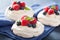 Pavlova meringue cake with cream and berry