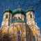 Pavlovsky Cathedral on a sunny spring day. Fragment. The blue sky, green domes and the yellow walls of the cathedral