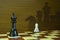 Pawn versus king in a chess game with shadows of chess pieces in the background
