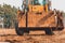 Paws of the excavator. The bucket excavator pulls up concrete slabs to set the road