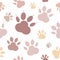 Paws pattern. Silhouettes of paws, cats feet, dogs footprint. Pastel pink, nude on a transparent background. Seamless