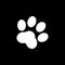 Paws vector icon isolated on black background.