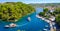 Paxos island panorama with boat entering the grand canal