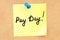 Pay Day! Text on a sticky note pinned to a corkboard. 3D rendering