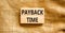 Payback time symbol. Concept words Payback time on wooden blocks. Beautiful canvas table canvas background. Business and payback