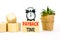 Payback time symbol. Concept words Payback time on wooden blocks. Beautiful white table white background. Black alarm clock. House