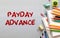 Payday advance is shown on the conceptual business photo