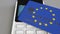 Payment or POS terminal with credit card featuring flag of the European Union. EU retail commerce or banking system