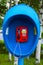 Payphone red with blue visor on  streets.