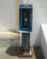 Payphone Remnants and Brick Building Facade