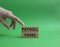 Payroll taxes symbol. Concept word Payroll taxes on wooden blocks. Beautiful green background. Businessman hand. Business and