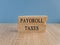 Payroll taxes symbol. Concept words