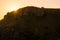 Paysage of hills and silhouettes of people on a sundown