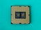 Pc micro CPU with gold plated contacts on a textured turquoise background. Modern central processing unit close-up. Desktop