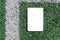 PC tablet flat lay on the sport synthetic green grass outdoors background.Blank white empty screen,mockup.Top view.Mockup