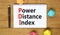 PDI power distance index symbol. Concept words PDI power distance index on white note on a beautiful wooden background. Metallic