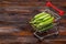 Pea pods in mini shopping cart. Healthy food concept