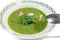 Pea soup puree in plate with parsley decoration.