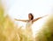 Peace, freedom and woman with arms raised at field outdoor in the countryside in spring. Person in nature, eyes closed