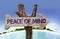 Peace of Mind wooden sign with a beach on background