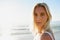 At peace with myself. Cropped portrait of an attractive young woman looking over her shoulder on the beach with the